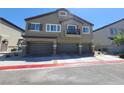 Two-story townhouse with a three-car garage and balcony on the second level at 4645 Fuchsia Nights Ave # 103, North Las Vegas, NV 89084
