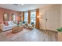 Bright living room featuring stylish furniture, hardwood flooring, and abundant natural light at 4839 Orchid Ridge Ave # 96, Las Vegas, NV 89141