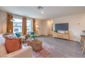 Living room featuring neutral colors, wood floors, and a large window for natural light at 4839 Orchid Ridge Ave # 96, Las Vegas, NV 89141