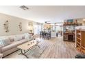 Spacious living room featuring wood floors, comfortable seating, and an open floor plan at 5017 Hadley Meadow Ct, Las Vegas, NV 89131