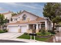Charming two-story home featuring a three-car garage, tiled roof, and well-maintained landscaping at 53 Grossinger Ct, Henderson, NV 89074
