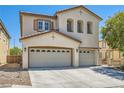 Charming two-story home with a three-car garage, stucco facade, and well-maintained landscaping at 5920 Big Horn View St, North Las Vegas, NV 89031