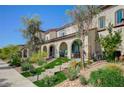 View of a townhome with manicured landscaping, arched entryways, and beautiful facade at 759 Pickled Pepper Pl, Henderson, NV 89011