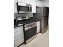 A well-lit kitchen with modern stainless steel appliances and white cabinets at 7885 W Flamingo Rd # 1064, Las Vegas, NV 89147