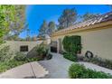 Lush landscaping adorns the walkway of this home with a gated entrance at 8121 Castle Pines Ave, Las Vegas, NV 89113