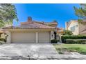 Charming home with a two-car garage, a red tile roof, and a neatly manicured lawn at 8121 Castle Pines Ave, Las Vegas, NV 89113