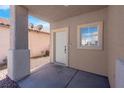 Covered front porch area with view of front door and small window at 8725 Russet Hills Ct, Las Vegas, NV 89147