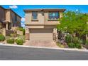 Charming two-story home featuring a paved driveway, attached two-car garage, and well-manicured front yard at 880 Cirrus Cloud Ave, Las Vegas, NV 89138