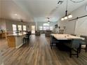 Bright, open-concept kitchen and living area with wood floors, high ceilings, and stylish barn door at 8928 Reining Spur Ave, Las Vegas, NV 89143