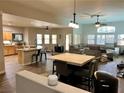 Spacious open-concept layout with an island kitchen that flows into the living and dining areas at 8928 Reining Spur Ave, Las Vegas, NV 89143