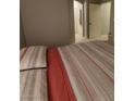 Cozy bedroom with red stripe bedding, neutral walls, and natural light at 9000 Las Vegas Blvd # 2061, Las Vegas, NV 89123