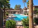 Community pool surrounded by lush landscaping and comfortable lounge chairs for relaxation at 9000 Las Vegas Blvd # 2097, Las Vegas, NV 89123