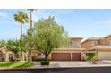 Traditional two-story home featuring a three-car garage, well-maintained landscaping, and a welcoming facade at 9615 Sedona Hills Ct, Las Vegas, NV 89147