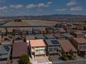 Aerial shot of a beige two-story home with a balcony in a desert neighborhood at 9742 Toad Hollow St, Las Vegas, NV 89141