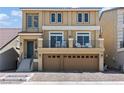 Two-story house with a front-facing balcony, a two-car garage, and a brick driveway at 9742 Toad Hollow St, Las Vegas, NV 89141