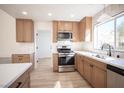 A bright kitchen featuring stainless appliances, light wood cabinets and a window above the sink at 9817 Kernville Dr, Las Vegas, NV 89134