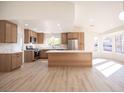 Bright, open kitchen with stainless appliances, light wood cabinets, an island and large windows for lots of natural light at 9817 Kernville Dr, Las Vegas, NV 89134