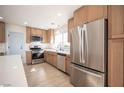 Beautiful kitchen featuring stainless steel appliances, wood cabinets and a view into other areas of the home at 9817 Kernville Dr, Las Vegas, NV 89134