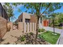 Neutral colored home with xeriscaped yard, small patch of grass, and well-maintained walkway at 100 Woolman Rink Ave, Las Vegas, NV 89123