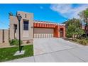 Charming single-Gathering home featuring a neutral palette and an attached two-car garage with an extra-long driveway at 100 Woolman Rink Ave, Las Vegas, NV 89123