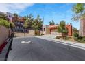 Exterior view of the home from street showing a gated entry and other homes at 100 Woolman Rink Ave, Las Vegas, NV 89123