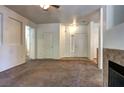 Open concept living room with fireplace, white walls, and view of hallway at 1000 Duckhorn Ct # 102, Las Vegas, NV 89144