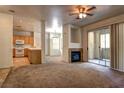 Open concept living room with fireplace, kitchen, and sliding doors to balcony at 1000 Duckhorn Ct # 102, Las Vegas, NV 89144