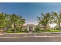 View of the community clubhouse featuring a well-maintained exterior and ample parking at 10205 Birch Bluff Ln, Las Vegas, NV 89145