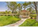 Charming gazebo surrounded by green lawn and landscaping creating an inviting outdoor space at 10205 Birch Bluff Ln, Las Vegas, NV 89145