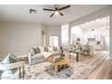Comfortable living room with stylish decor, wood floors, and an open layout to the kitchen at 10205 Birch Bluff Ln, Las Vegas, NV 89145
