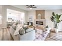 Cozy living room with modern furnishings, an electric fireplace, and open access to the kitchen at 10205 Birch Bluff Ln, Las Vegas, NV 89145