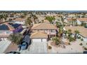 Aerial view of home with tile roof, mature landscaping, sparkling pool and ample parking at 1066 Aspen Valley Ave, Las Vegas, NV 89123