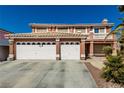 Beautiful two-story home featuring a three-car garage, second-story balcony, and well-manicured landscaping at 1066 Aspen Valley Ave, Las Vegas, NV 89123