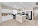 This well-lit kitchen features white cabinets, stainless appliances, and a marble-top island at 11074 Caramel Crest Ct, Las Vegas, NV 89135