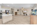 Open-concept kitchen and living area with sleek floors and fireplace at 11074 Caramel Crest Ct, Las Vegas, NV 89135