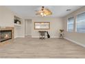 Living room with a fireplace, ceiling fan, and a large mirror at 11074 Caramel Crest Ct, Las Vegas, NV 89135