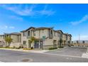 A row of modern townhomes with neutral exteriors, complemented by well-kept landscaping and easy street parking at 12107 Frost Lime Rd # 1, Las Vegas, NV 89183