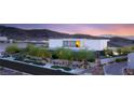 Modern house exterior boasting sleek design, mature trees, and manicured landscaping on a private drive at 13 Rockstream Dr, Henderson, NV 89012
