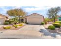 Single-story home featuring xeriscaped landscaping, two car garage, and an American flag at 1781 Cypress Lake Ct, Henderson, NV 89012