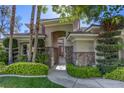 Inviting entrance with mature trees and stone accents that enhances the curb appeal of the property at 2008 Winter Wind St, Las Vegas, NV 89134