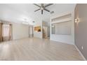 Bright living room featuring hardwood floors, neutral wall, and a modern ceiling fan at 2156 Eagle Sticks Dr, Henderson, NV 89012