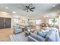 Open concept living space with a ceiling fan, neutral decor, and wood-look floors at 2581 Terrytown Ave, Henderson, NV 89052