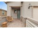 Welcoming front porch with stone accents, tiled floor, and wicker seating at 2624 Stanhurst Ave, North Las Vegas, NV 89081