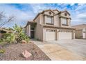 Two-story home featuring desert landscaping and a spacious two-car garage, offering curb appeal at 271 Sunshine Springs Ct, Henderson, NV 89014