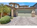 Charming home showcasing a brick-accented facade, well-maintained landscaping, and a spacious two-car garage at 3136 Mossfield Ave, Henderson, NV 89052