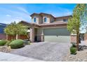 Inviting two-story home with a brick-accented entrance and a well-maintained front yard at 3136 Mossfield Ave, Henderson, NV 89052