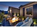 Inviting outdoor fire pit area with comfortable seating and lush landscaping at 33 Desert Juniper Ln, Henderson, NV 89011