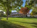 Sprawling single-story home with a long porch, surrounded by a well-manicured lawn and mature trees at 330 Rancho Cir, Las Vegas, NV 89107
