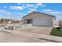 Charming single-story home with a well-manicured lawn and white picket fence at 3409 Judson Ave, North Las Vegas, NV 89030
