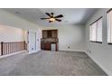 Cozy bonus room upstairs with carpet flooring, ceiling fan, and bar area at 3809 Alpine Track Ave, North Las Vegas, NV 89032
